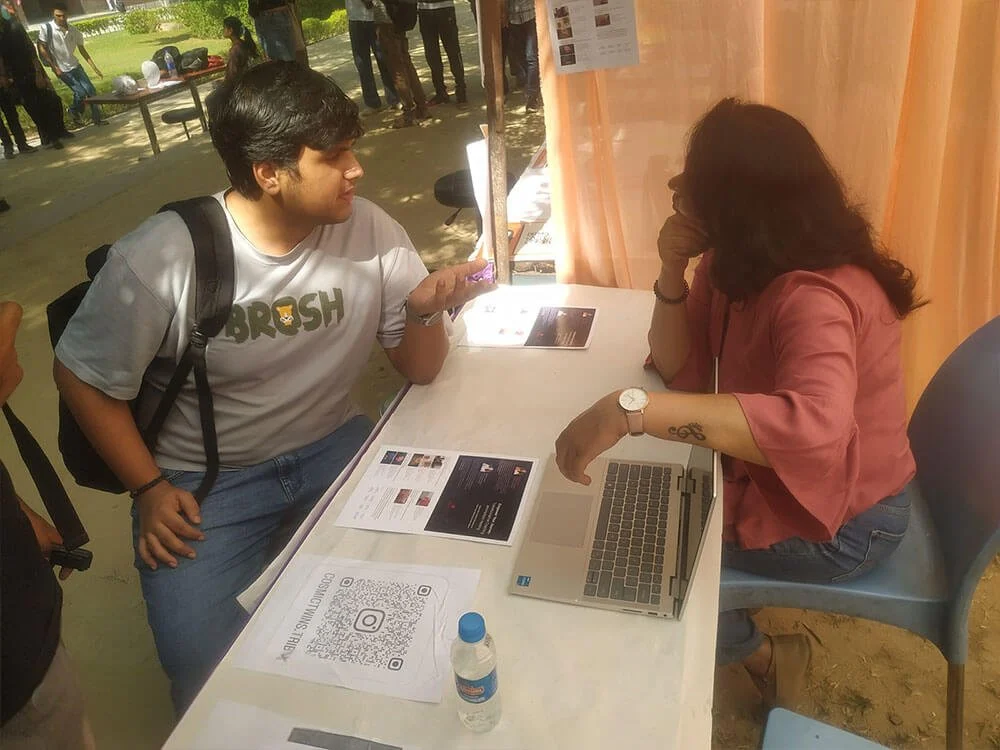 Swati speaking one-to-one with a student at the awareness camp