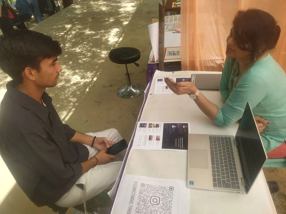 Swati speaking one-to-one with another student at the awareness camp